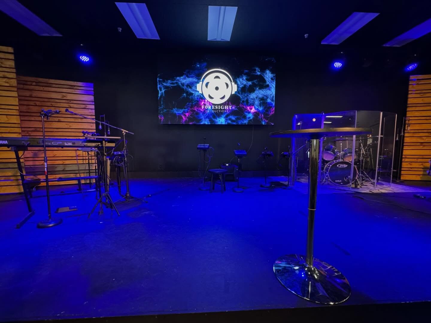 Church stage with an LED video wall displaying the Foresight Productions logo, band setup in front