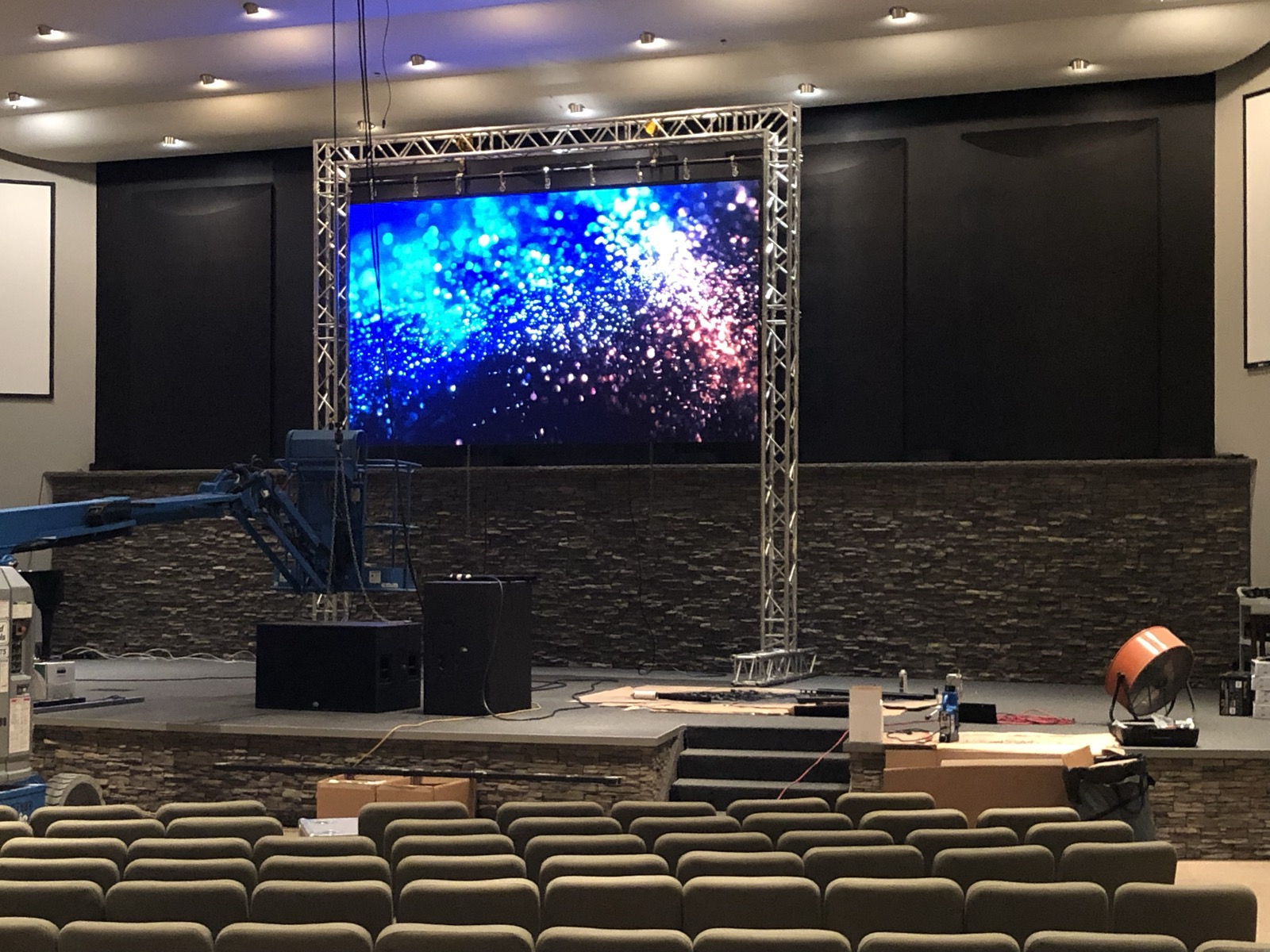 LED video wall mounted on a ground-support truss frame during installation in a church auditorium